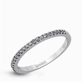 This eye-catching contemporary white gold engagement ring and wedding band set features an impressive halo accented by .63 ctw round cut white diamonds.