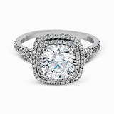 This remarkable white gold engagement ring and wedding band set features a contemporary setting with an eye-catching halo highlighted by .67 ctw of round cut white diamonds.
