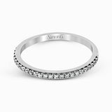 This remarkable white gold engagement ring and wedding band set features a contemporary setting with an eye-catching halo highlighted by .67 ctw of round cut white diamonds.