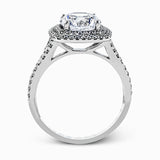 This remarkable white gold engagement ring and wedding band set features a contemporary setting with an eye-catching halo highlighted by .67 ctw of round cut white diamonds.