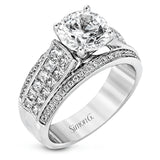 This impressive modern white gold ring features .18 ctw of glimmering round cut white diamonds accentuated by .97 ctw princess cut diamonds.