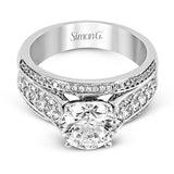 This impressive modern white gold ring features .18 ctw of glimmering round cut white diamonds accentuated by .97 ctw princess cut diamonds.