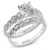 Classically designed, yet featuring a modern flair, this delicate white gold engagement ring and wedding band set are accentuated with .28 ctw round cut white diamonds and .46 ctw marquise cut diamonds.