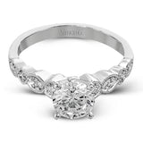 Classically designed, yet featuring a modern flair, this delicate white gold engagement ring and wedding band set are accentuated with .28 ctw round cut white diamonds and .46 ctw marquise cut diamonds.