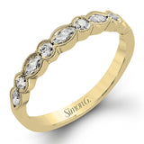 Classically designed, yet featuring a modern flair, this delicate white gold engagement ring and wedding band set are accentuated with .28 ctw round cut white diamonds and .46 ctw marquise cut diamonds.