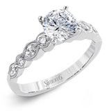 Classically designed, yet featuring a modern flair, this delicate white gold engagement ring and wedding band set are accentuated with .28 ctw round cut white diamonds and .46 ctw marquise cut diamonds.