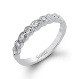 Classically designed, yet featuring a modern flair, this delicate white gold engagement ring and wedding band set are accentuated with .28 ctw round cut white diamonds and .46 ctw marquise cut diamonds.