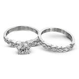 Classically designed, yet featuring a modern flair, this delicate white gold engagement ring and wedding band set are accentuated with .28 ctw round cut white diamonds and .46 ctw marquise cut diamonds.