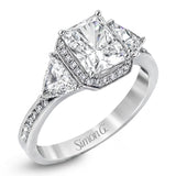This dazzling contemporary white gold ring showcases a romantic setting featuring a remarkable halo and .19 ctw of round cut white diamonds accented by .68 ctw trillion diamonds.