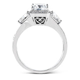 This dazzling contemporary white gold ring showcases a romantic setting featuring a remarkable halo and .19 ctw of round cut white diamonds accented by .68 ctw trillion diamonds.