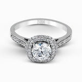 Showcasing a dazzling halo, this contemporary white gold wedding set is highlighted by .45 ctw of arresting round cut white diamonds.