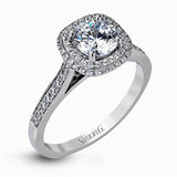 Showcasing a dazzling halo, this contemporary white gold wedding set is highlighted by .45 ctw of arresting round cut white diamonds.