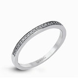 Showcasing a dazzling halo, this contemporary white gold wedding set is highlighted by .45 ctw of arresting round cut white diamonds.