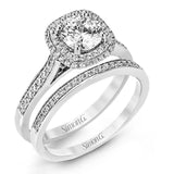 Showcasing a dazzling halo, this contemporary white gold wedding set is highlighted by .45 ctw of arresting round cut white diamonds.