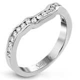 Featuring a lovely romantic setting, this white gold contemporary ring features an exquisite halo and .33 ctw of shimmering round cut white diamonds complemented by .34 ctw of trapezoid side diamonds.