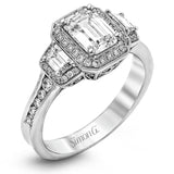 Featuring a lovely romantic setting, this white gold contemporary ring features an exquisite halo and .33 ctw of shimmering round cut white diamonds complemented by .34 ctw of trapezoid side diamonds.