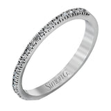 Accented by .46 ctw of glistening round cut white diamonds, this contemporary white gold halo style engagement ring and wedding band set makes a dramatic statement.