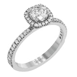 Accented by .46 ctw of glistening round cut white diamonds, this contemporary white gold halo style engagement ring and wedding band set makes a dramatic statement.