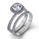 Accented by .46 ctw of glistening round cut white diamonds, this contemporary white gold halo style engagement ring and wedding band set makes a dramatic statement.