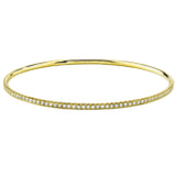Featuring a charming classic style, this yellow gold bangle bracelet is inset with .86 ctw of dazzling round white diamonds in a lovely channel setting. Perfect for stacking.