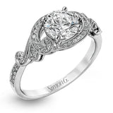 This lovely modern white gold engagement ring features a memorable halo and is accentuated by .19 ctw glistening round cut white diamonds.