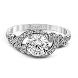 This lovely modern white gold engagement ring features a memorable halo and is accentuated by .19 ctw glistening round cut white diamonds.