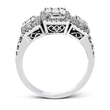 This amazing vintage-inspired ring features three halos and contains .52 ctw of round brilliant diamonds and .41 ctw of baguette diamonds.
