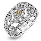 The delicate floral design of this white and yellow gold band is complemented by .53 ctw of round cut white diamonds and .04 ctw of round cut yellow diamond accents.