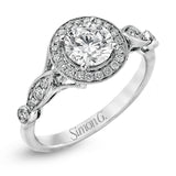This sparkling white gold vintage inspired engagement ring features an exquisite halo and is set with .25 ctw round cut white diamonds.