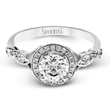 This sparkling white gold vintage inspired engagement ring features an exquisite halo and is set with .25 ctw round cut white diamonds.