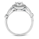 This sparkling white gold vintage inspired engagement ring features an exquisite halo and is set with .25 ctw round cut white diamonds.