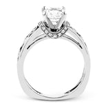 Set with delicate floral patterns, this classic white gold engagement ring is highlighted with .12 ctw round cut white diamonds.