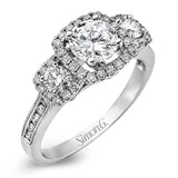 This dramatic contemporary white gold ring is accentuated by .37 ctw round cut white diamonds and features .30 ctw glimmering side stones.