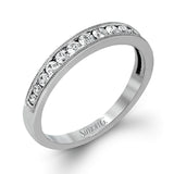 This dramatic contemporary white gold ring is accentuated by .37 ctw round cut white diamonds and features .30 ctw glimmering side stones.