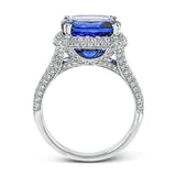 This eye-catching white gold ring is set with a remarkable 5.34 ctw sapphire accentuated by .68 ctw glistening round cut white diamonds.