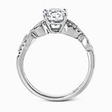 Featuring a distinctively romantic design, this white gold engagement ring and band are set with .22 ctw of round cut white diamonds, .09 ctw of marquise cut diamonds, and .13 ctw pear-shaped diamonds.