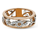 This impressive white and rose gold band is highlighted by a vintage style floral design inset with .09 ctw round cut white diamonds and .01 ctw round cut pink diamonds.