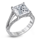 This lovely classic white gold engagement ring is accentuated by .34 ctw of round cut white diamonds in an eye-catching openwork design.