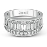 This impressive white gold ring features 1.53 ctw of arresting baguette cut diamonds surrounded by 1.37 ctw princess cut diamonds.