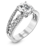 The lovely vintage style of this white gold engagement ring is further enhanced by .91 ctw of shimmering round cut diamonds.