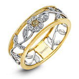 Reflecting a charming vintage floral design, this white and yellow gold band is accentuated by .09 ctw round cut white diamonds and .01 ctw round cut yellow diamonds.