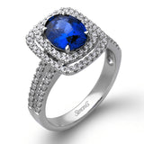 This arresting white gold ring features a classic design set with a 1.90 ctw natural sapphire silhouetted by twin silhouettes accented by .51 ctw of round white diamonds.