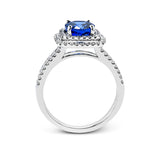 This arresting white gold ring features a classic design set with a 1.90 ctw natural sapphire silhouetted by twin silhouettes accented by .51 ctw of round white diamonds.