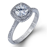Classy and elegant, this contemporary white gold halo engagement ring and wedding band set is set with .34 ctw of round cut white diamonds.