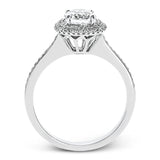 Classy and elegant, this contemporary white gold halo engagement ring and wedding band set is set with .34 ctw of round cut white diamonds.