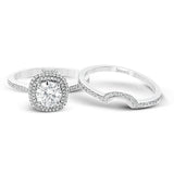 Classy and elegant, this contemporary white gold halo engagement ring and wedding band set is set with .34 ctw of round cut white diamonds.