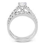 Elevating a classic design with modern elements, this exquisite white gold engagement ring and band are emphasized by .77 ctw of sparkling round cut white diamonds.