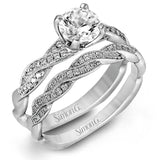 Featuring a modern design, this elegant white gold engagement ring and wedding band set are accentuated by .22 ctw of shimmering round cut white diamonds.