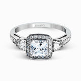 Featuring an intricate design, this white gold engagement ring is emphasized by .26 ctw of round cut white diamonds and .23 ctw of shimmering princess cut white diamonds.