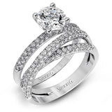 This impressive contemporary white gold engagement ring and wedding band set are emphasized by 1.00 ctw of dazzling round cut white diamonds.